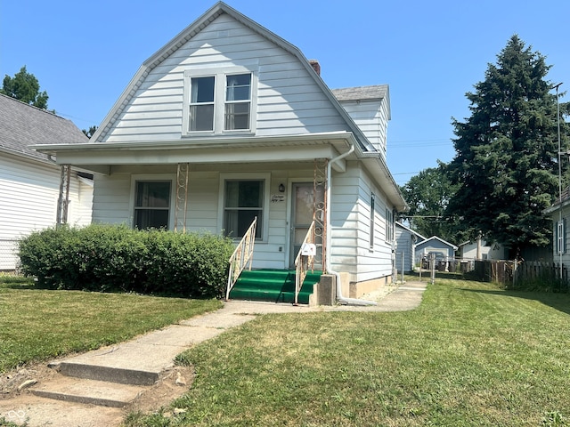 1652 High St, Fort Wayne, IN 46808 - colonial inspired home with a gambrel roof, a porch, a front lawn, and a chimney