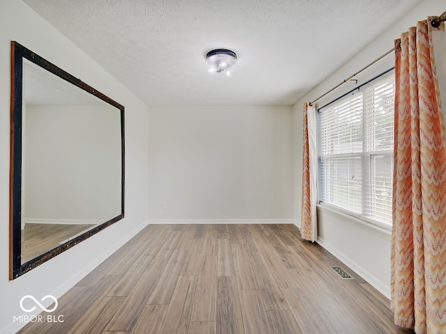 3902 Jekyll Ct, Indianapolis, IN 46237 - spare room with wood finished floors and a textured ceiling