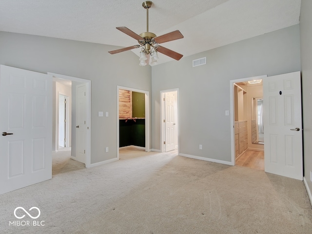 3902 Jekyll Ct, Indianapolis, IN 46237 - unfurnished bedroom featuring light colored carpet, high vaulted ceiling, a walk in closet, and ensuite bath