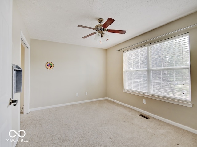 3902 Jekyll Ct, Indianapolis, IN 46237 - empty room with carpet floors, a ceiling fan, plenty of natural light, and a textured ceiling