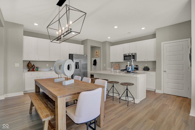 948 Shadow Dr, Danville, IN 46122 - dining area with light wood-type flooring, recessed lighting, and a chandelier