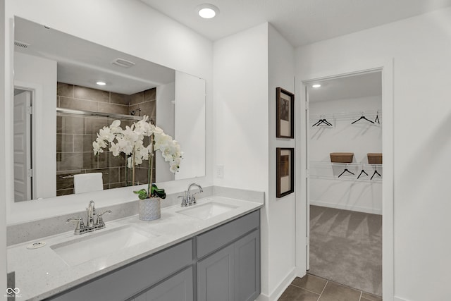 924 Shadow Dr, Danville, IN 46122 - bathroom featuring a walk in closet, tile patterned floors, double vanity, and a stall shower