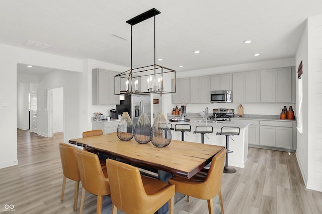 924 Shadow Dr, Danville, IN 46122 - dining room with light wood-type flooring, recessed lighting, and a chandelier