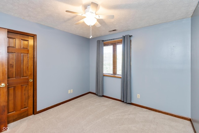 6926 Princess Ln, Avon, IN 46123 - spare room featuring light carpet, a textured ceiling, and ceiling fan