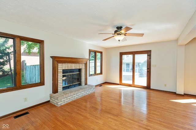 6926 Princess Ln, Avon, IN 46123 - unfurnished living room with light wood-type flooring, a ceiling fan, and a fireplace