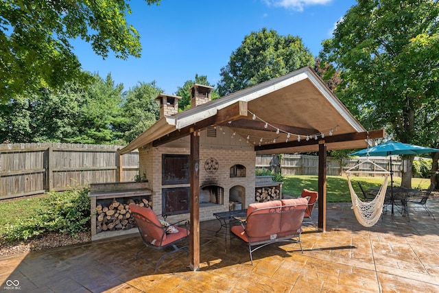 6926 Princess Ln, Avon, IN 46123 - fenced backyard featuring a patio area and an outdoor living space with a fireplace