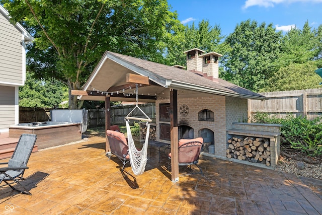 6926 Princess Ln, Avon, IN 46123 - fenced backyard with an outdoor brick fireplace, a patio, and a hot tub