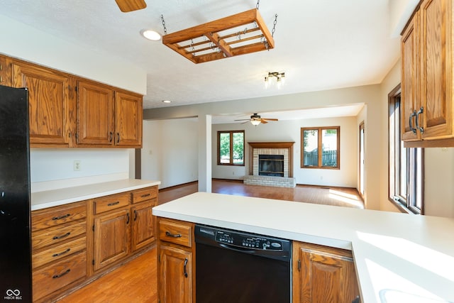 6926 Princess Ln, Avon, IN 46123 - kitchen featuring black appliances, ceiling fan, light countertops, light wood finished floors, and brown cabinets