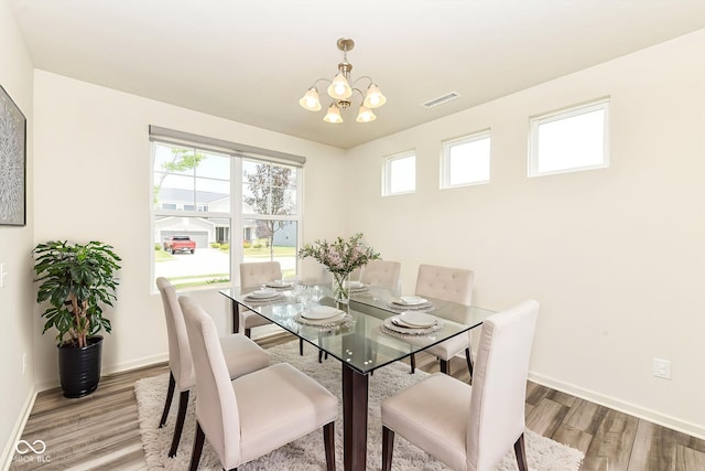 7101 Oak Trace Ln, Brownsburg, IN 46112 - dining area featuring wood finished floors and a chandelier