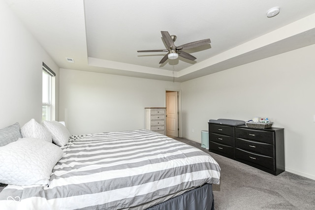 7101 Oak Trace Ln, Brownsburg, IN 46112 - carpeted bedroom featuring a tray ceiling and ceiling fan