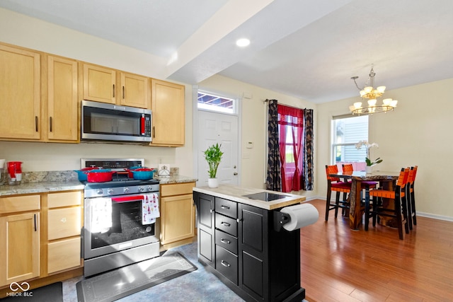 2454 N Talbott St, Indianapolis, IN 46205 - kitchen with appliances with stainless steel finishes, light brown cabinetry, a chandelier, light countertops, and wood finished floors