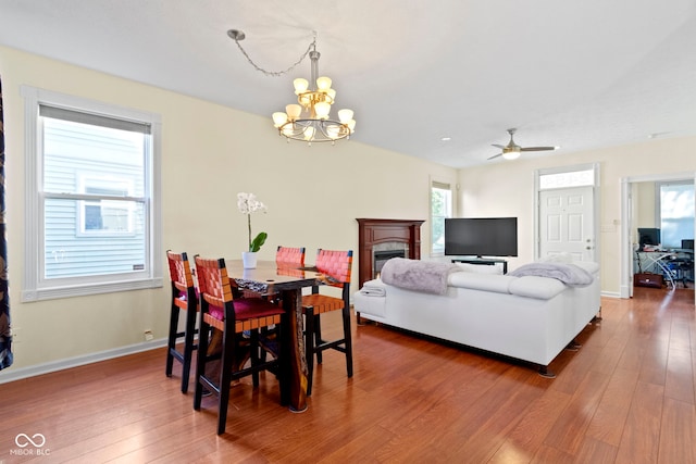 2454 N Talbott St, Indianapolis, IN 46205 - dining room with hardwood / wood-style floors, a chandelier, ceiling fan, and a fireplace