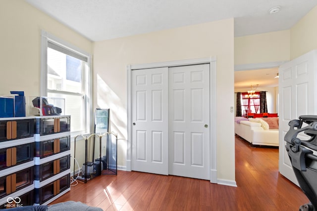 2454 N Talbott St, Indianapolis, IN 46205 - bedroom with wood finished floors, multiple windows, a closet, and a chandelier