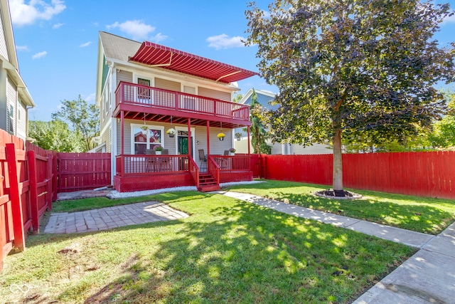2454 N Talbott St, Indianapolis, IN 46205 - rear view of house with a fenced backyard, a balcony, and a fire pit