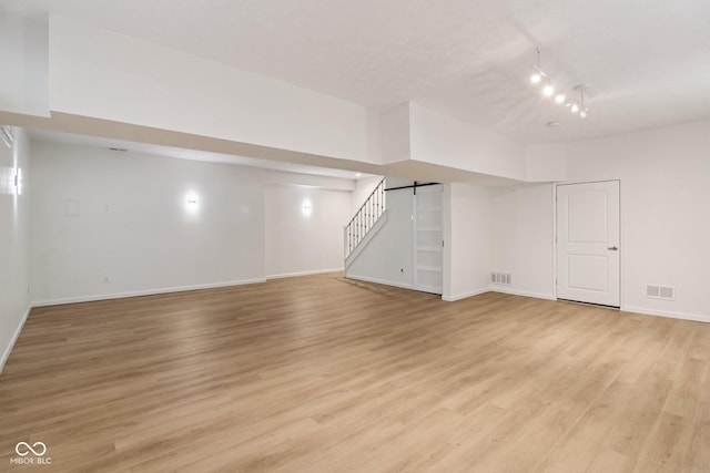 11845 Discovery Cir, Indianapolis, IN 46236 - finished below grade area featuring light wood-style flooring, a barn door, and stairway