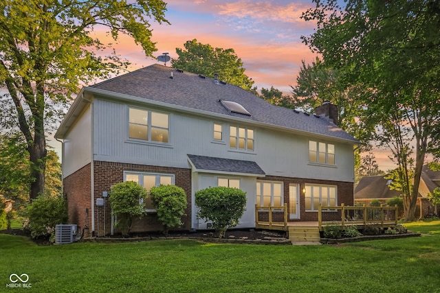 11845 Discovery Cir, Indianapolis, IN 46236 - back of house featuring brick siding, a deck, a chimney, and a lawn