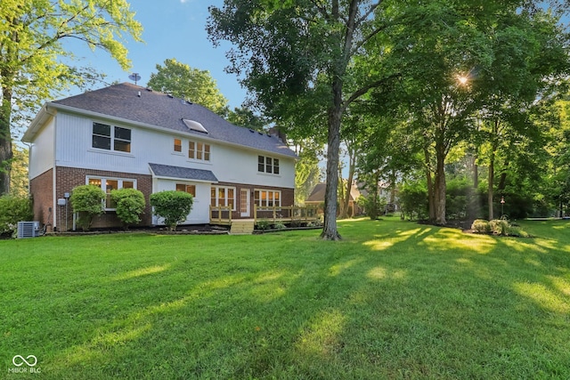 11845 Discovery Cir, Indianapolis, IN 46236 - back of house with brick siding, a lawn, a deck, and a shingled roof