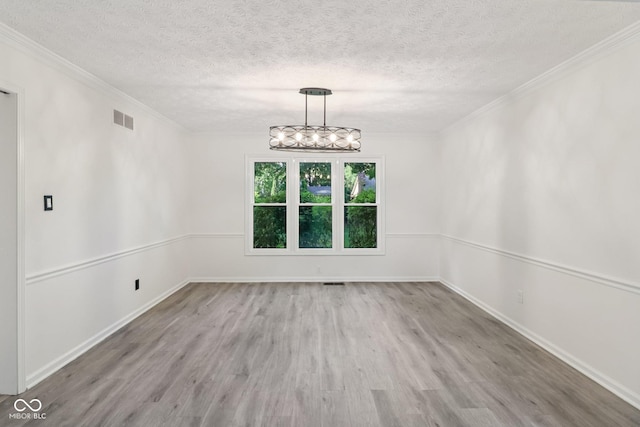 11845 Discovery Cir, Indianapolis, IN 46236 - unfurnished dining area featuring wood finished floors, a textured ceiling, crown molding, and a chandelier