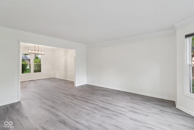 11845 Discovery Cir, Indianapolis, IN 46236 - unfurnished room with crown molding, a chandelier, and wood finished floors