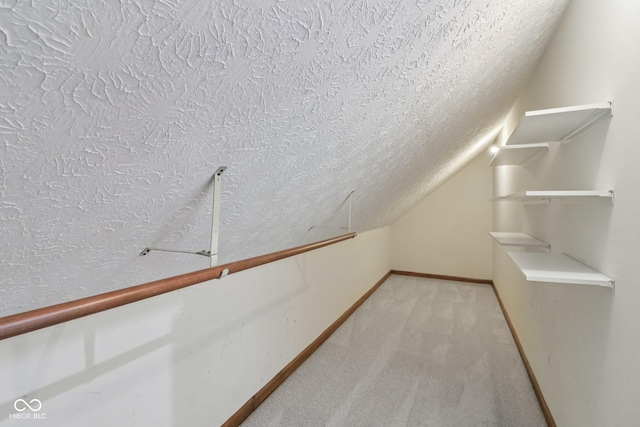 11845 Discovery Cir, Indianapolis, IN 46236 - walk in closet featuring light carpet and vaulted ceiling