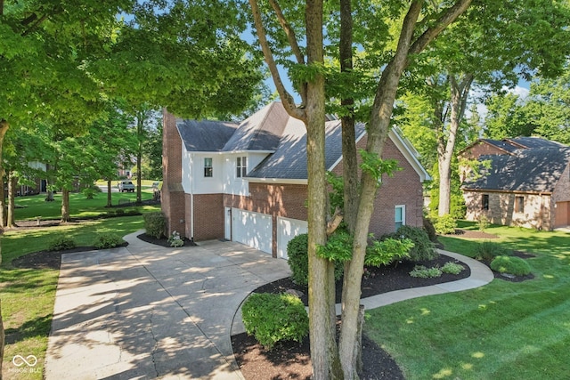 11845 Discovery Cir, Indianapolis, IN 46236 - view of property exterior with brick siding, concrete driveway, a yard, and roof with shingles