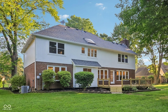 11845 Discovery Cir, Indianapolis, IN 46236 - back of property with brick siding, a deck, a chimney, a yard, and a shingled roof