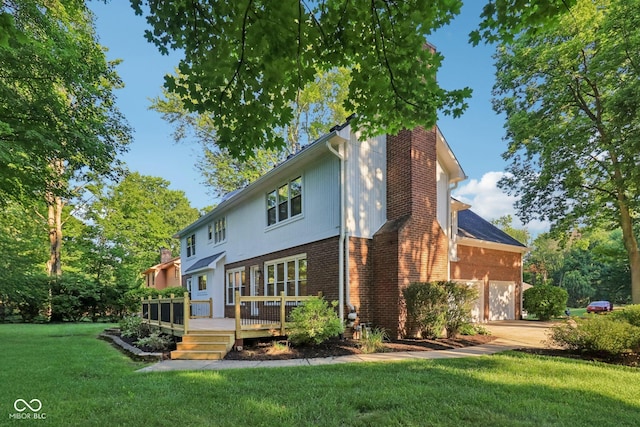 11845 Discovery Cir, Indianapolis, IN 46236 - rear view of house with brick siding, a deck, a lawn, a chimney, and concrete driveway