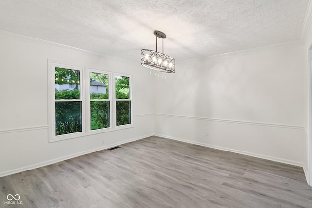 11845 Discovery Cir, Indianapolis, IN 46236 - empty room with a textured ceiling, crown molding, wood finished floors, and a chandelier