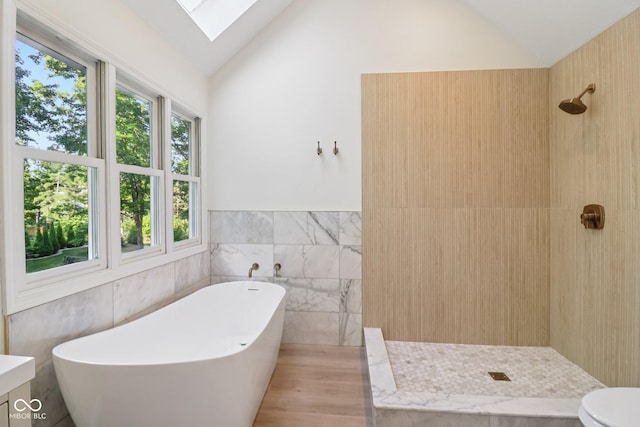 11845 Discovery Cir, Indianapolis, IN 46236 - full bath featuring tile walls, lofted ceiling, a freestanding tub, a tile shower, and a skylight