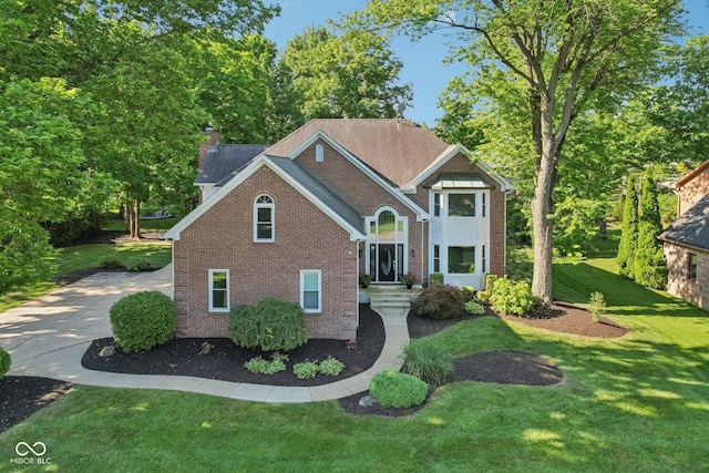 11845 Discovery Cir, Indianapolis, IN 46236 - view of front of property featuring brick siding, a front lawn, driveway, and a chimney