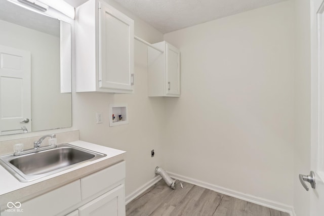 11845 Discovery Cir, Indianapolis, IN 46236 - washroom with hookup for a washing machine, hookup for an electric dryer, light wood-type flooring, cabinet space, and a textured ceiling