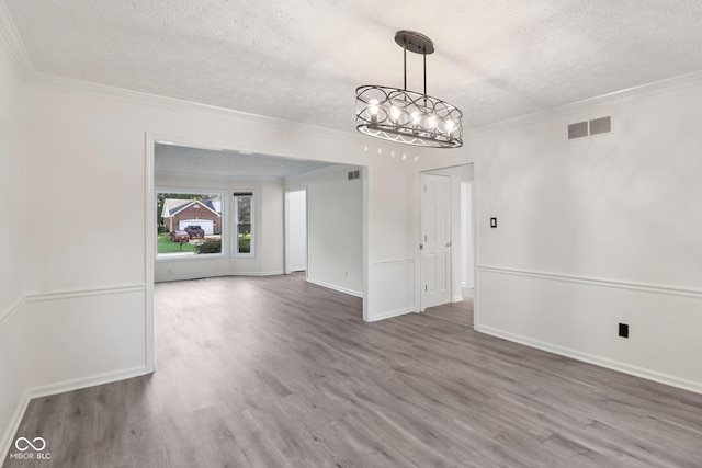 11845 Discovery Cir, Indianapolis, IN 46236 - unfurnished dining area with a textured ceiling, wood finished floors, ornamental molding, and a chandelier