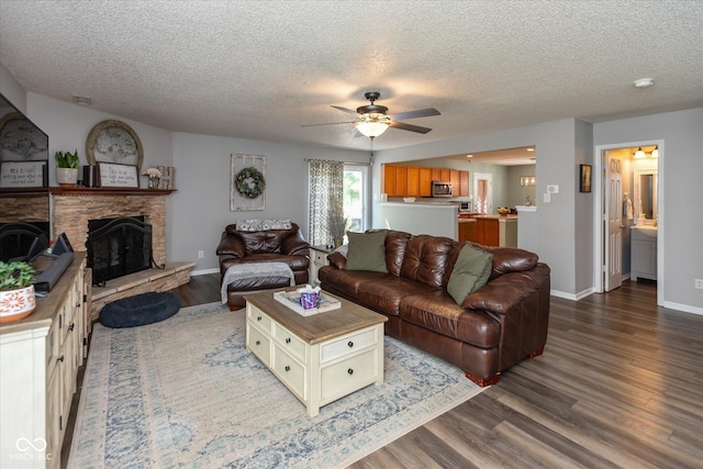 7950 Crackling Ln, Indianapolis, IN 46259 - living area featuring ceiling fan, wood finished floors, a textured ceiling, and a fireplace
