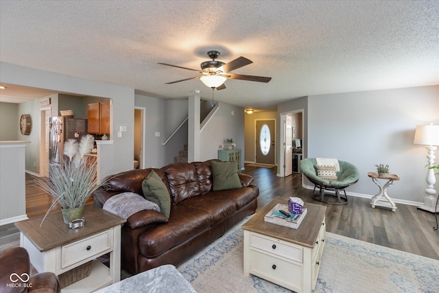 7950 Crackling Ln, Indianapolis, IN 46259 - living room featuring a ceiling fan, wood finished floors, a textured ceiling, and stairway