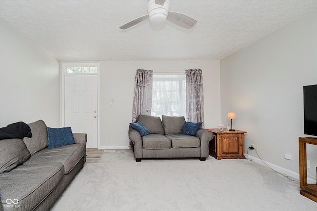 2466 Sickle Rd, Indianapolis, IN 46219 - living room with healthy amount of natural light, light colored carpet, a textured ceiling, and ceiling fan