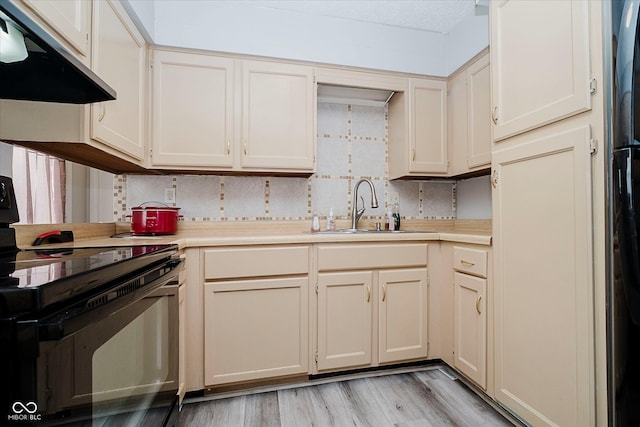 2466 Sickle Rd, Indianapolis, IN 46219 - kitchen featuring black range with electric stovetop, exhaust hood, light countertops, light wood-type flooring, and decorative backsplash
