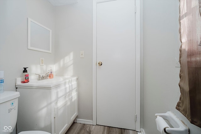 2466 Sickle Rd, Indianapolis, IN 46219 - half bathroom featuring vanity and wood finished floors