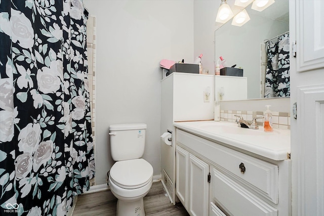 2466 Sickle Rd, Indianapolis, IN 46219 - bathroom featuring tasteful backsplash, vanity, wood finished floors, and a shower with curtain