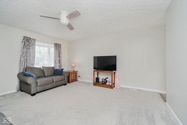 2466 Sickle Rd, Indianapolis, IN 46219 - living area with light carpet, a textured ceiling, and a ceiling fan