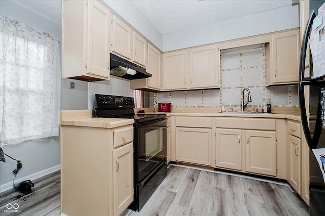 2466 Sickle Rd, Indianapolis, IN 46219 - kitchen with black / electric stove, under cabinet range hood, light wood finished floors, light countertops, and a textured ceiling