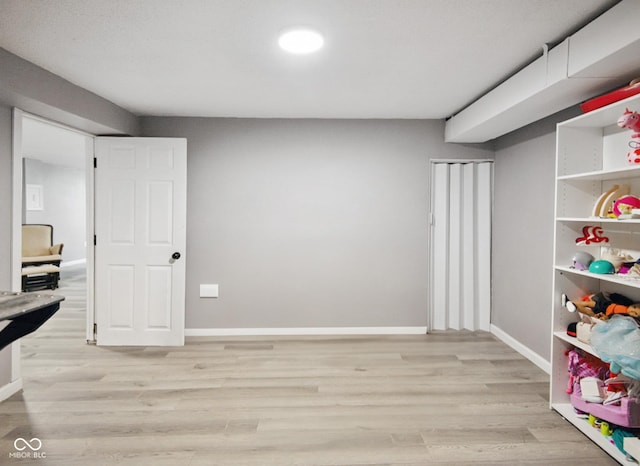 1743 Chandler Ln, Columbus, IN 47203 - recreation room with light wood-style flooring and baseboards
