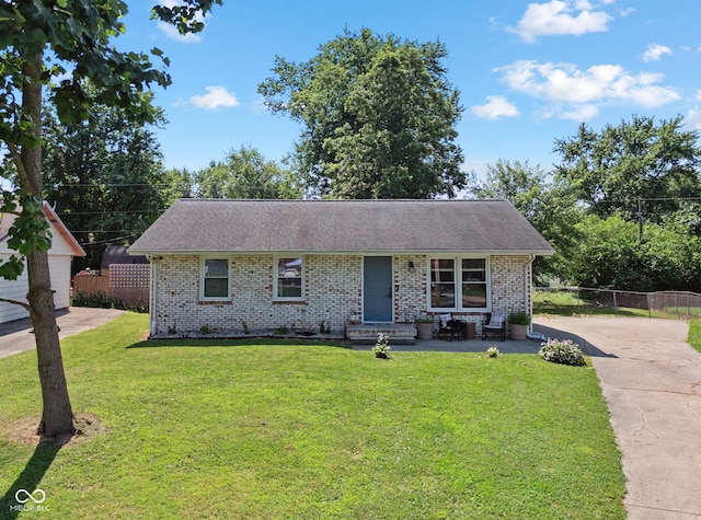 1743 Chandler Ln, Columbus, IN 47203 - view of front of home with brick siding, concrete driveway, entry steps, and roof with shingles
