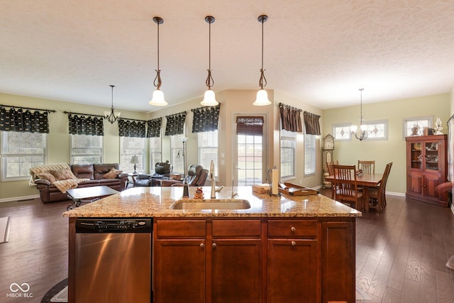 1387 Mayfield Ct, Westfield, IN 46074 - kitchen featuring stainless steel dishwasher, a chandelier, open floor plan, dark wood finished floors, and a textured ceiling