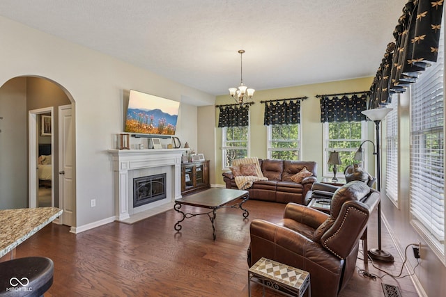 1387 Mayfield Ct, Westfield, IN 46074 - living room with plenty of natural light, arched walkways, dark wood-type flooring, and a chandelier