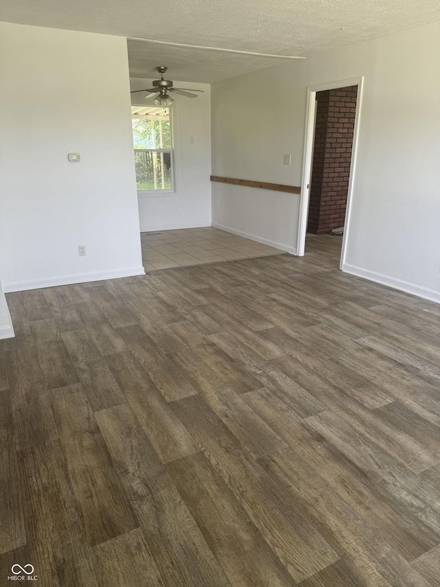 1831 N Main St, Franklin, IN 46131 - empty room featuring dark wood-type flooring, ceiling fan, and a textured ceiling