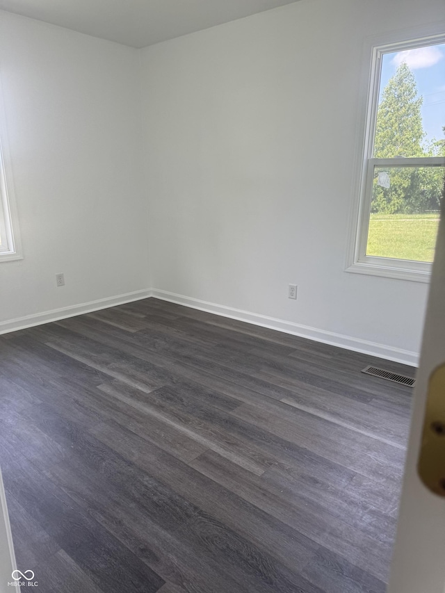 1831 N Main St, Franklin, IN 46131 - empty room featuring dark wood-type flooring and baseboards