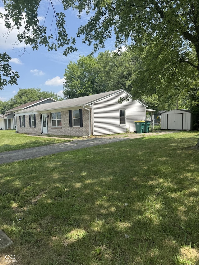 1831 N Main St, Franklin, IN 46131 - ranch-style home with a storage unit, a front lawn, and brick siding