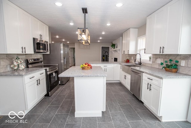 7950 N 475 E, Columbus, IN 47203 - kitchen with stainless steel appliances, tasteful backsplash, white cabinets, and recessed lighting