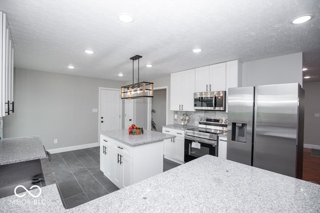 7950 N 475 E, Columbus, IN 47203 - kitchen featuring appliances with stainless steel finishes, tasteful backsplash, recessed lighting, white cabinets, and a center island