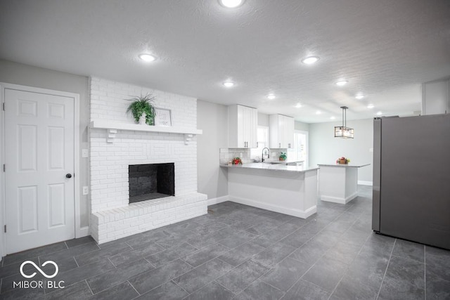 7950 N 475 E, Columbus, IN 47203 - living area featuring recessed lighting, a fireplace, a textured ceiling, and dark tile patterned flooring